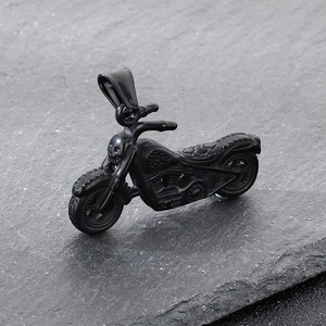 Macro detail of a punk rock motorcycle pendant with skull on dark stone background