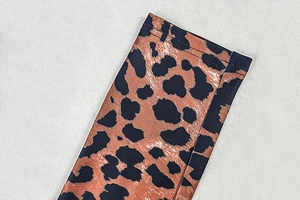 Close-up of leopard print jumpsuit showing high-quality stitching and fabric texture