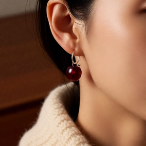 Close-up of S925 silver C-shape earring with deep red translucent apple pendant
