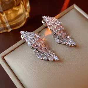 Elegant silver wing-shaped earrings with marquise-cut cubic zirconia in a jewelry box