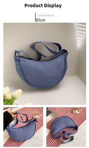 Detail shot of navy blue nylon crescent bag with adjustable wide shoulder strap and zipper