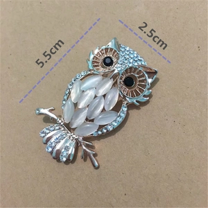 Silver owl brooch with cat-eye stone and blue rhinestones detail, size 5.5cm x 2.5cm