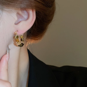 Detail of square faux tiger eye stone charm on gold plated hoop earrings for women