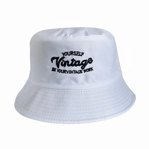 Close-up of vintage white cotton canvas bucket hat featuring black letter embroidery