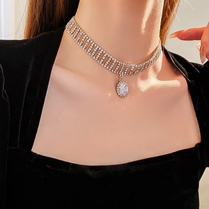 Close-up of multi-layer sparkling rhinestone choker necklace with oval crystal pendant