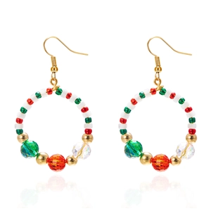 Macro detail of Christmas wreath hoop earrings with festive red green and white beads
