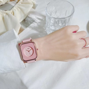 Chic pink square quartz watch with rose gold case on wrist, minimalist student style