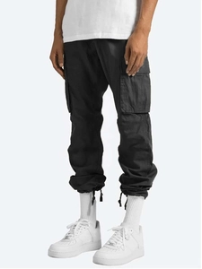 Detail of cargo trousers showing side flap pockets and high-quality cotton fabric texture
