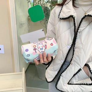 Detail of handheld cylindrical canvas pencil case with cute rabbit print and side lanyard