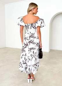 Back view of floral tiered midi dress with puff sleeves and elastic shirred waist