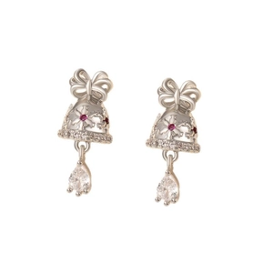 Silver bell drop earrings with bow and red gems on a minimalist white background