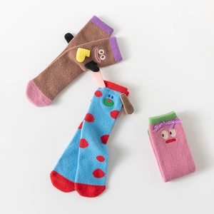 Close-up of cute cartoon coral fleece socks with Barbapapa characters for kids