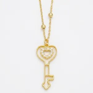 Elegant gold heart key pendant necklace with micro-paved zircons and beaded chain