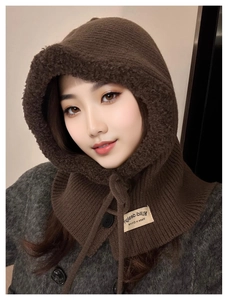 Detail of brown knitted winter balaclava with fleece lining and drawstring closure