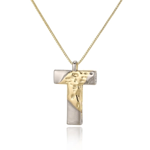 Close-up of dual-tone T-letter pendant with hammered gold texture and box chain
