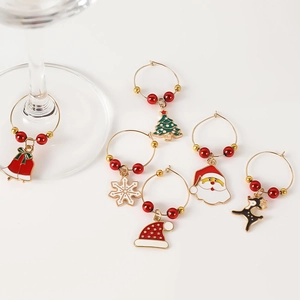 Detail of 6 Christmas wine glass markers with alloy charms and beads on white background