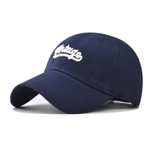 Close-up of white 3D stereo embroidery Vintage text on navy cotton baseball cap