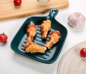 Deep green ceramic square grill pan with handle and realistic grilled chicken wings