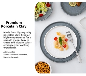 Detail view of French minimalist ceramic dinnerware with white plates and grey salad bowls