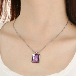 Macro shot of rectangular purple crystal pendant on a sleek stainless steel snake chain
