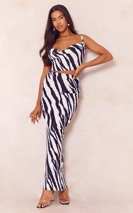 Detail of zebra print pleated fabric on a slim-fit camisole top and matching maxi skirt set