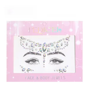Detailed view of iridescent face jewels and pearls on display card for party makeup