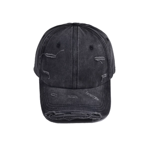 Macro detail of distressed edges and ripped holes on charcoal denim baseball cap