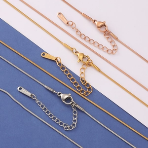 Detailed view of snake bone necklaces in rose gold, gold, and silver stainless steel finishes