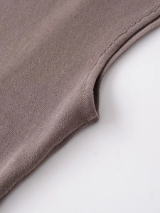 Detailed close-up of brown knit tank top neckline showing high-quality stitching texture