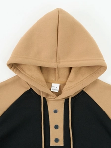 Detail view of khaki hoodie collar with metal snap button and polyester fabric texture