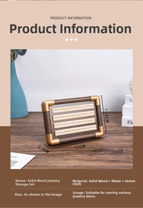 Detail view of walnut wood jewelry tray with beige velvet slots and metal corners