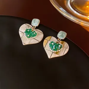 Exquisite heart-shaped dangle earrings with green marble patterns and pearl edge details