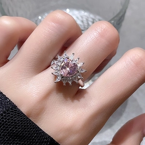 Detail of flower-shaped ring featuring heart-cut pink zircon and marquise-cut stones