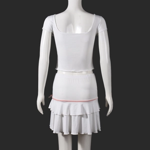 Rear view of white backless top and tiered mini skirt set with pink ribbon detail