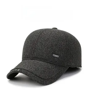 Detail of grey winter baseball cap with thick wool texture and side metal emblem