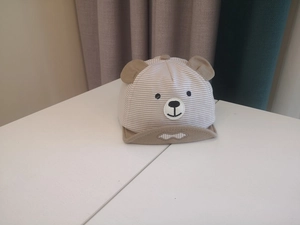 Detail of baby striped baseball cap with 3D bear ears and cute cartoon face embroidery