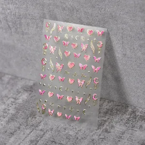Detail of 3D embossed nail art stickers with gold stars, moon, and pink butterflies