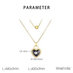 Detail showing gold layered necklace with black heart pendant and evil eye design
