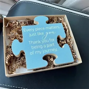 Blue puzzle piece gift decor with inspiring quote in a premium kraft gift box