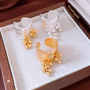 18K gold plated irregular wavy ring set with dangling beads in a wooden jewelry box