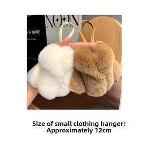 Detail view showing 12cm mini faux fur coat keychains in cream and caramel colors