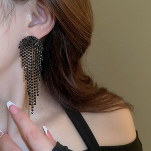 Close-up of elegant black rhinestone tassel earrings with a long cascading fringe design