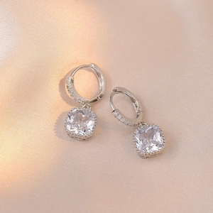 Silver drop earrings with square-cut clear zircon and beaded edge on champagne silk