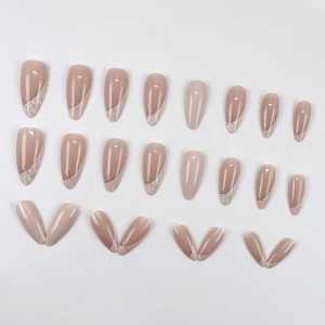 Almond-shaped press-on nails with nude pink base, white leaf patterns and silver glitter