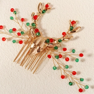 Detail of a vintage golden reindeer hair comb with festive red and green crystal beads