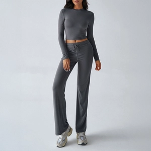 Women's 2-piece grey lounge set featuring a long sleeve crop top and wide-leg sweatpants