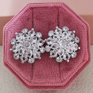 Elegant silver flower stud earrings with sparkling cubic zirconia in a pink velvet box