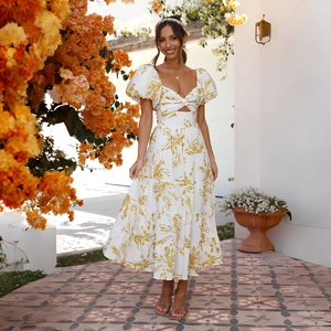 Detail of white floral midi dress featuring puff sleeves and a stylish front cutout design