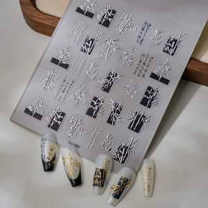 Detailed 3D embossed silver bamboo nail stickers with Chinese calligraphy on model nails
