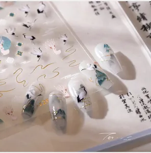Detail of Chinese style nail stickers featuring cranes and mountains with gold foil